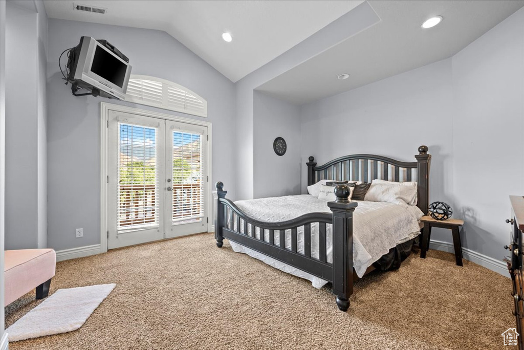 Bedroom featuring lofted ceiling, french doors, carpet flooring, and access to outside