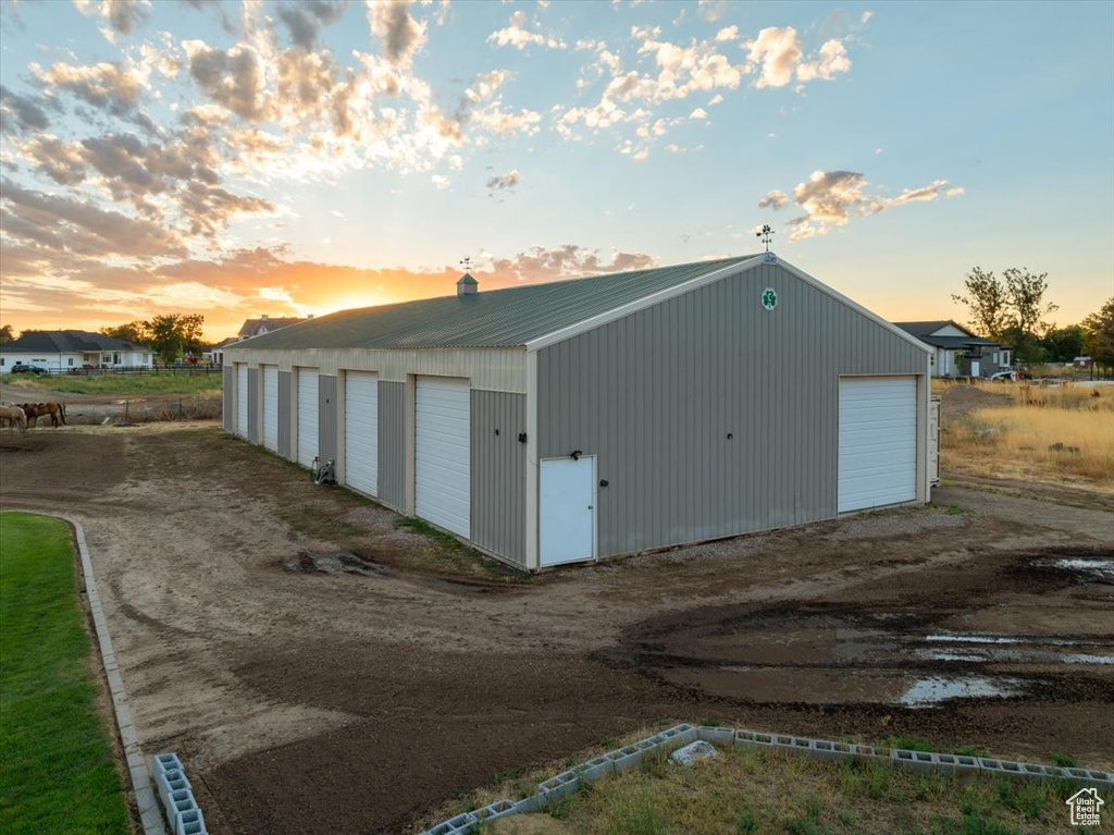 Outdoor structure at dusk featuring a garage