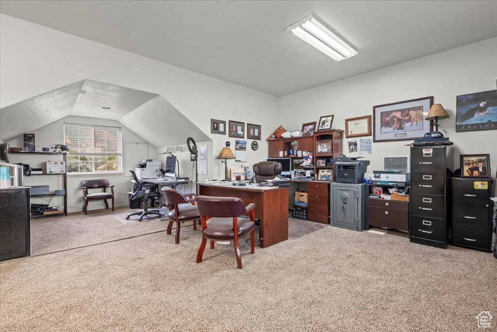 Office area with carpet and lofted ceiling