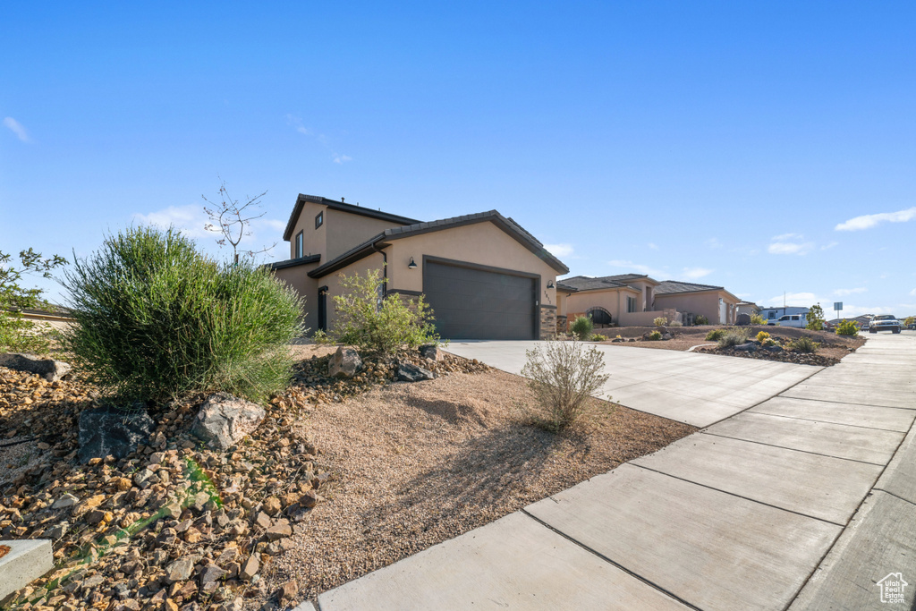 View of property exterior with a garage