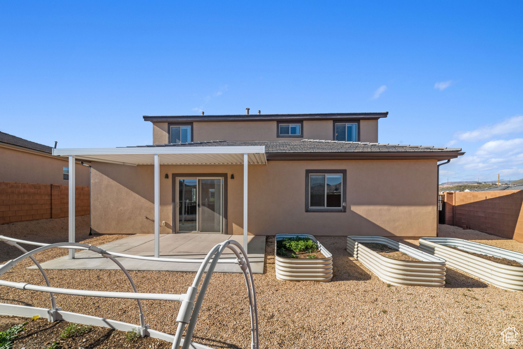 Rear view of property featuring a patio