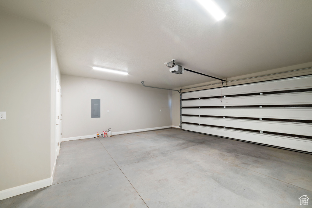 Garage with electric panel and a garage door opener