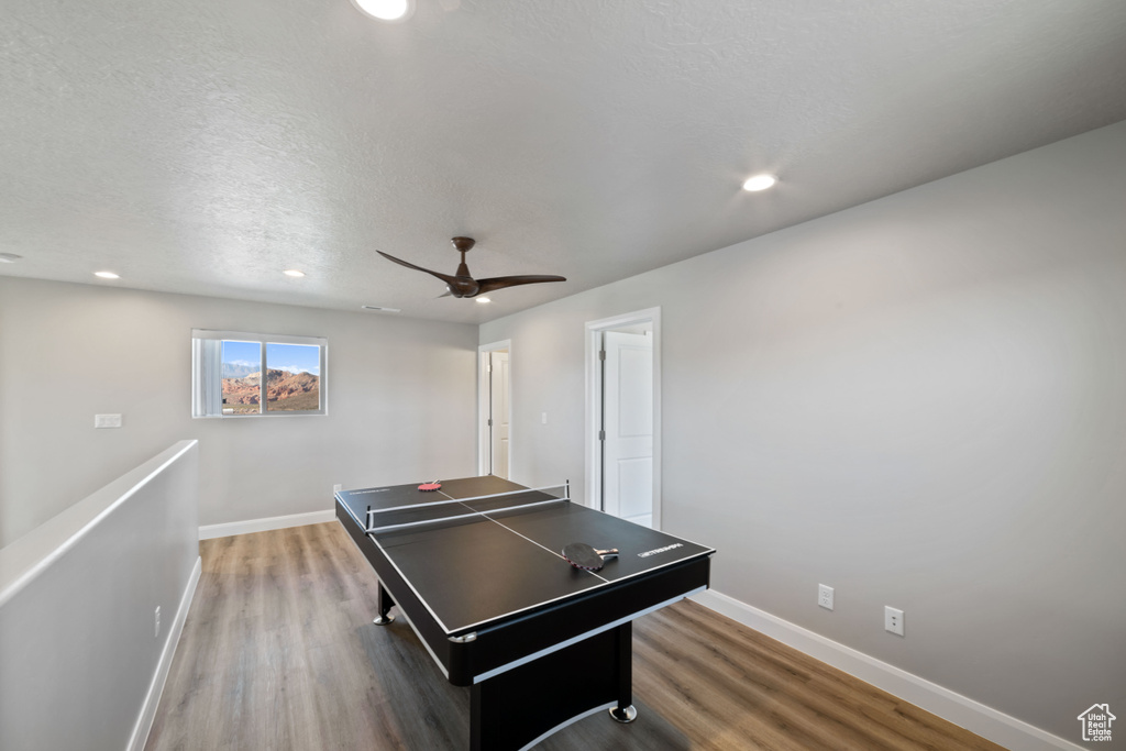 Game room with a textured ceiling, hardwood / wood-style flooring, and ceiling fan