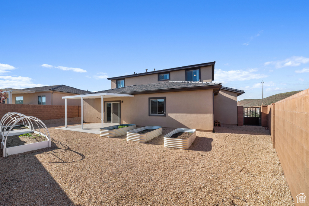 Back of house with a patio area