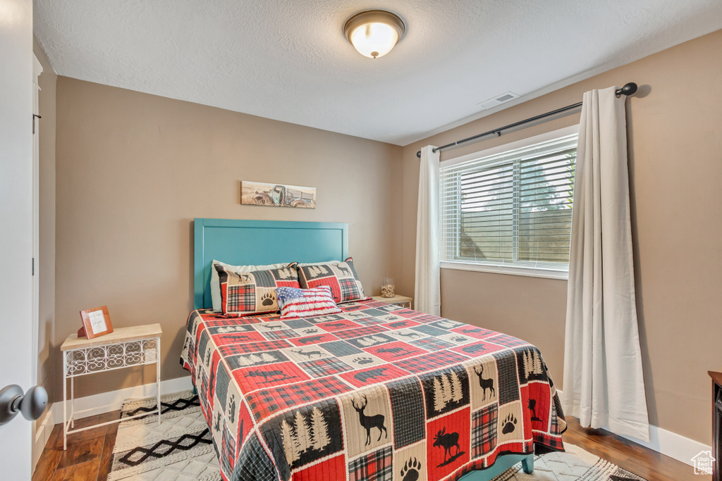 Bedroom with wood-type flooring