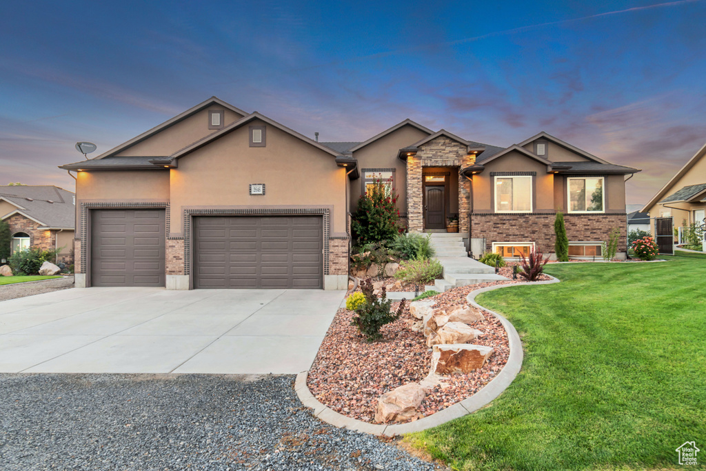 Craftsman inspired home with a garage and a lawn