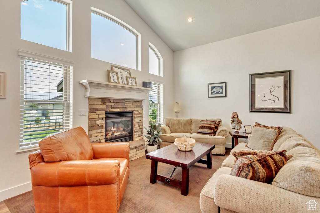 Living room with a high ceiling and a fireplace