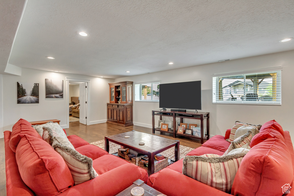 Living room with hardwood / wood-style flooring and a textured ceiling