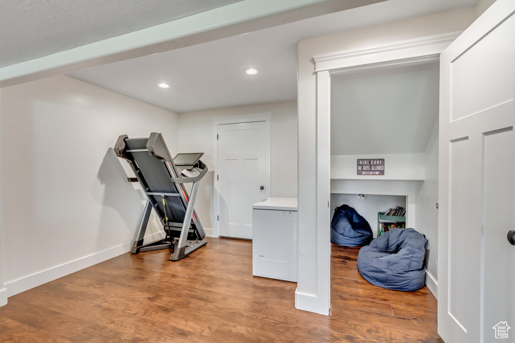 Exercise room with hardwood / wood-style flooring