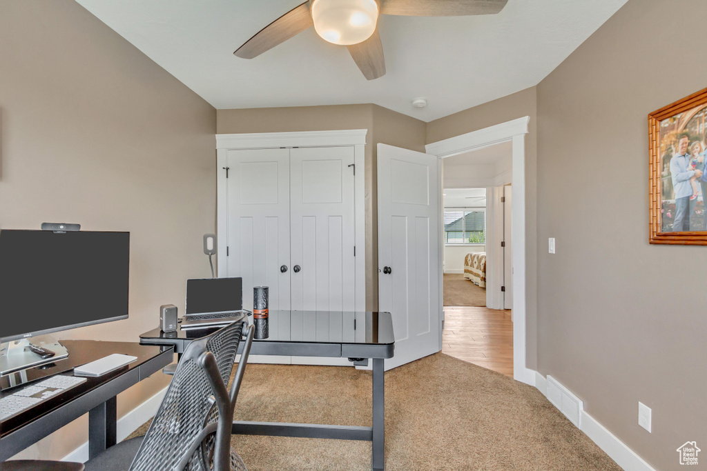 Home office with carpet and ceiling fan