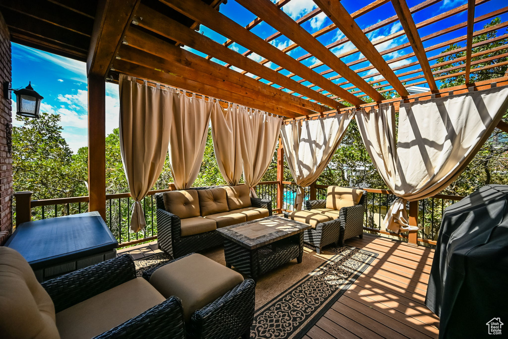 Wooden deck with a pergola and outdoor lounge area