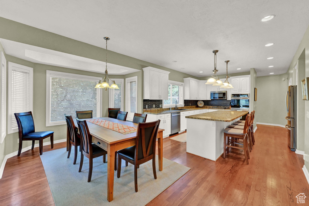 Dining area featuring sink and light hardwood / wood-style flooring