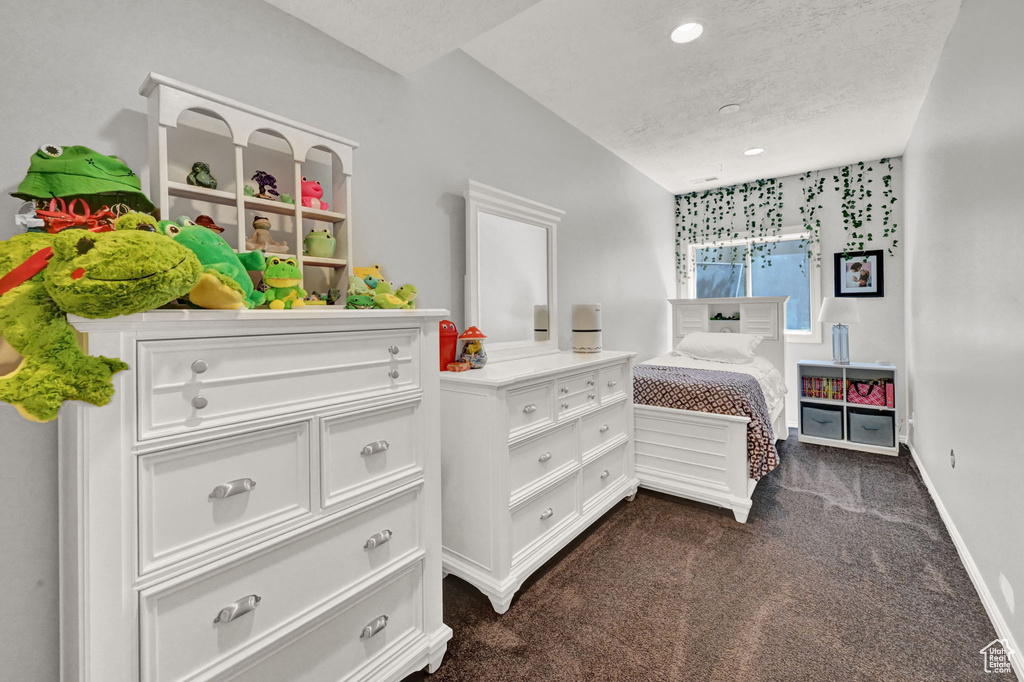 Carpeted bedroom featuring a textured ceiling