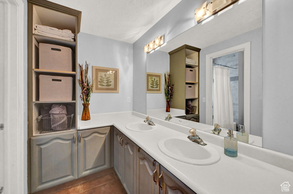 Bathroom featuring dual vanity and tile patterned floors