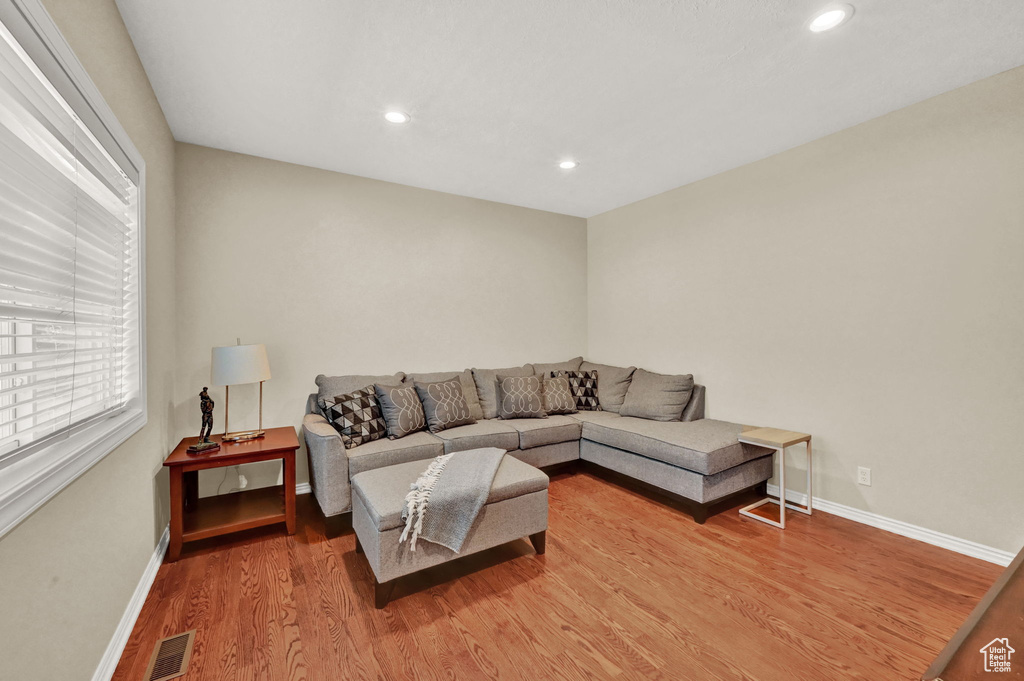 Living room with hardwood / wood-style flooring