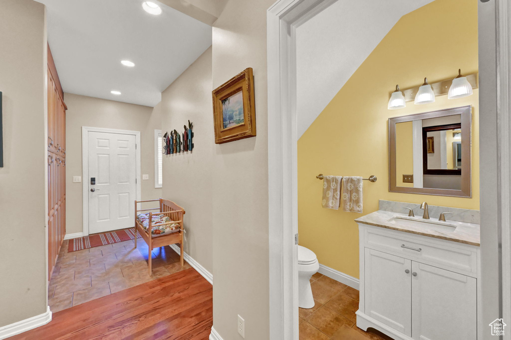 Corridor with sink and light tile patterned floors