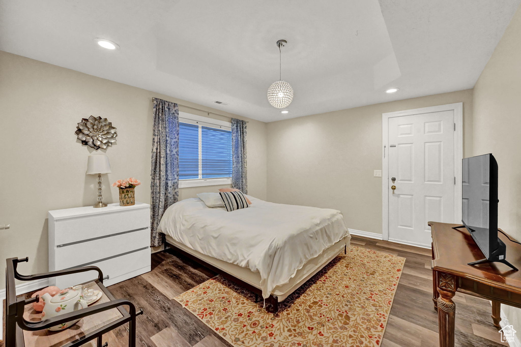 Bedroom with dark hardwood / wood-style floors