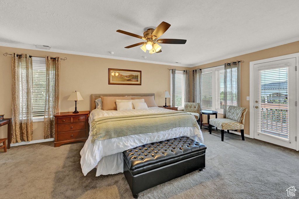 Bedroom with access to outside, ceiling fan, ornamental molding, and light colored carpet