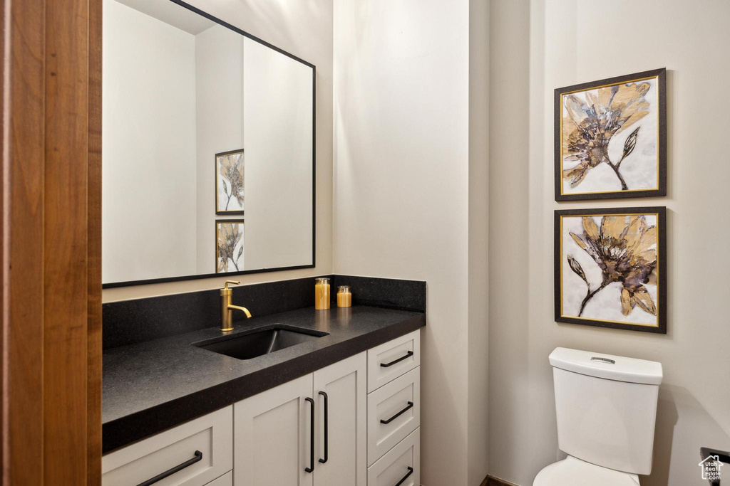 Bathroom featuring vanity and toilet