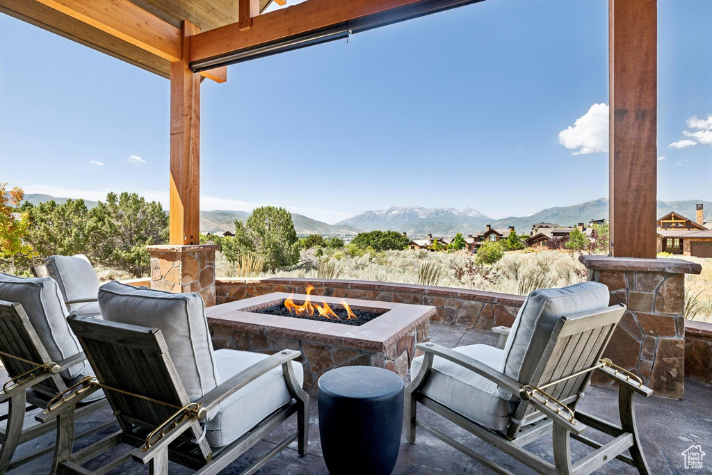 View of patio featuring a mountain view and a fire pit