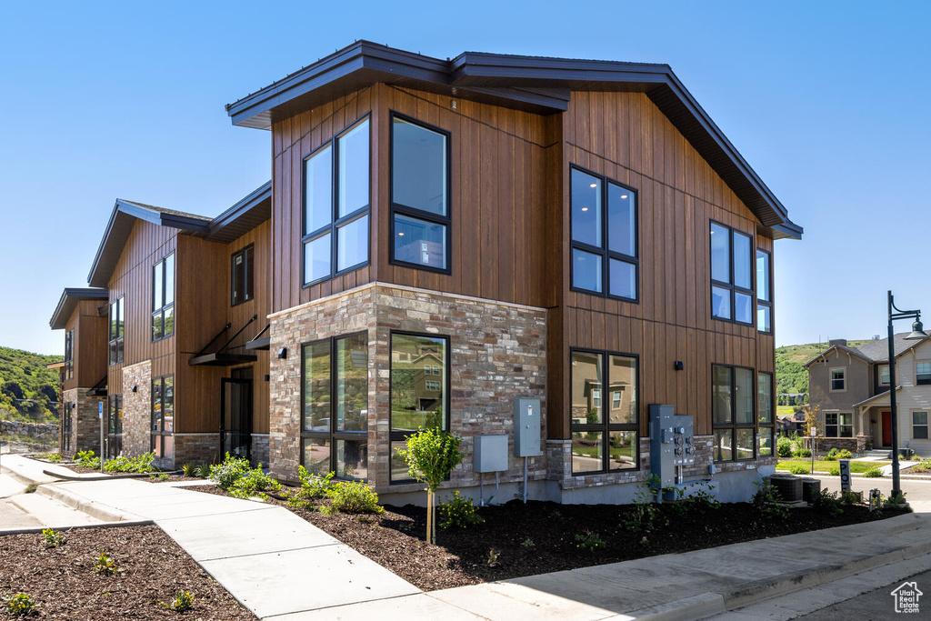 View of front of property featuring central AC unit