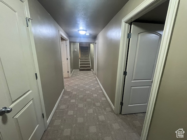 Hallway with dark carpet