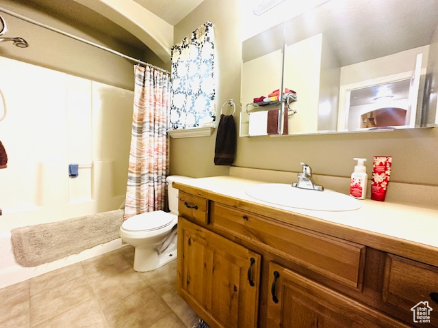 Bathroom with tile patterned floors, vanity, and toilet