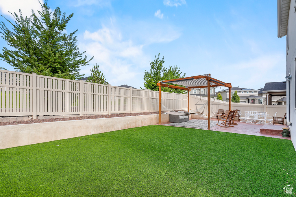 View of yard featuring a pergola and a patio