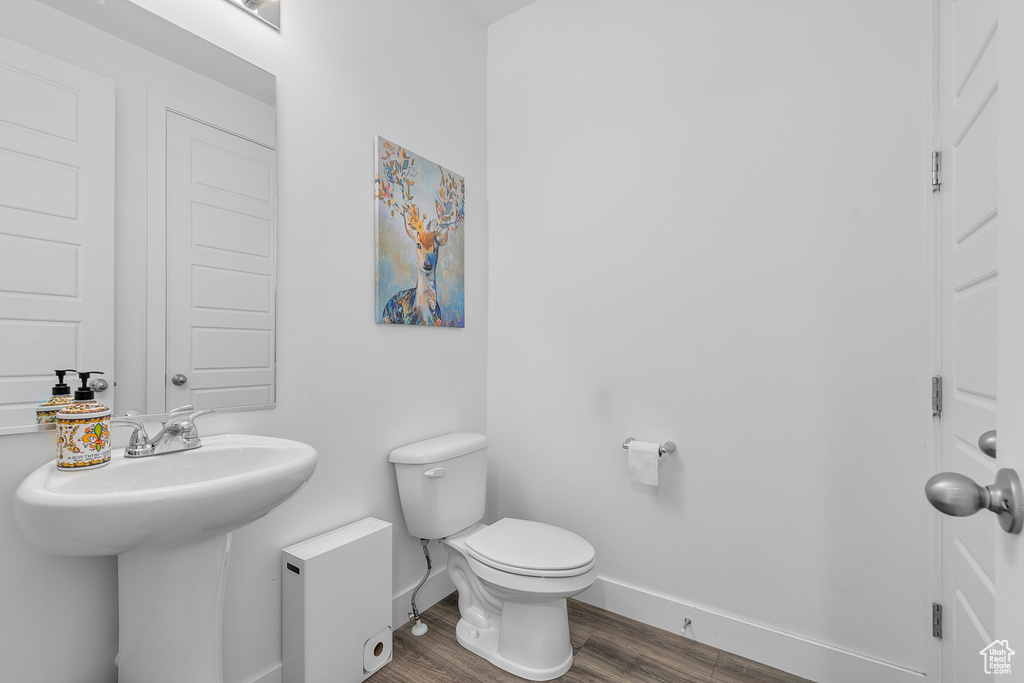 Bathroom featuring toilet and hardwood / wood-style flooring