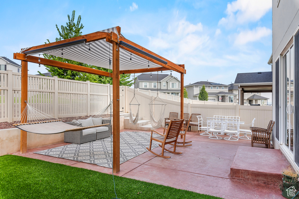 View of patio with an outdoor hangout area