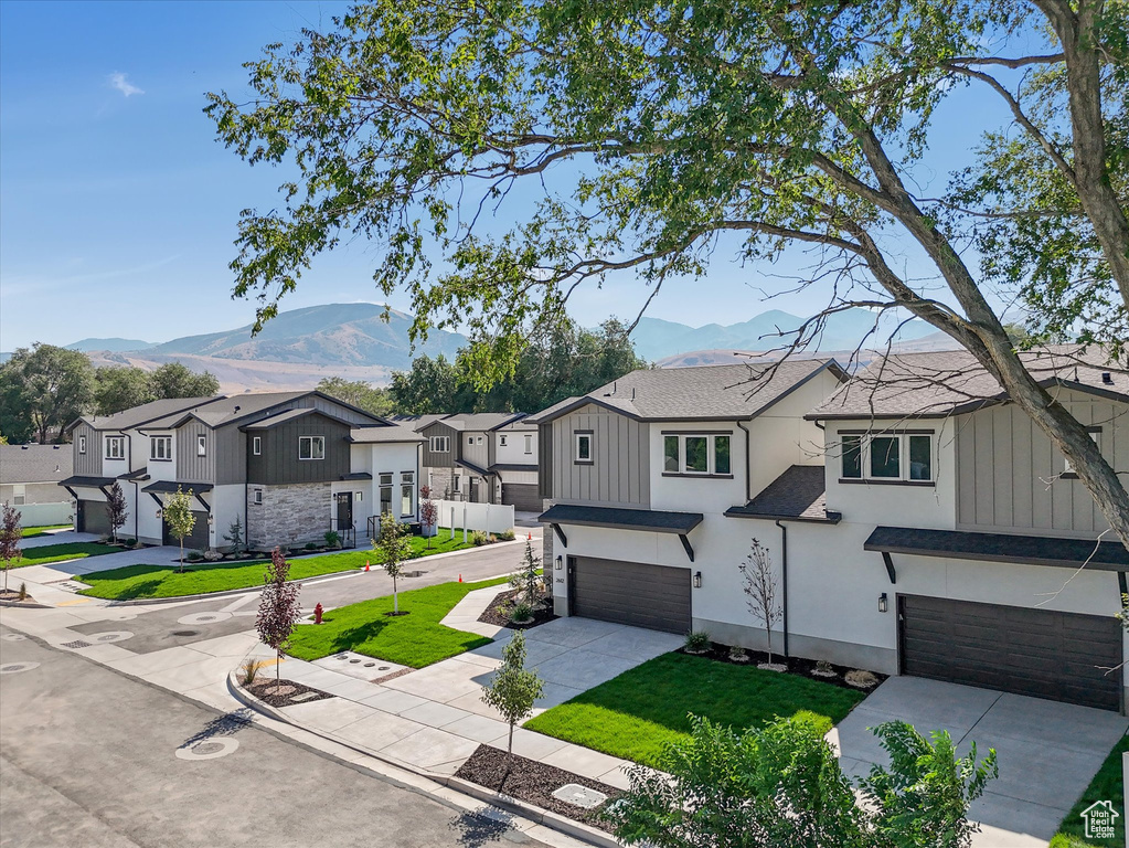 View of front of house featuring a mountain view and a garage