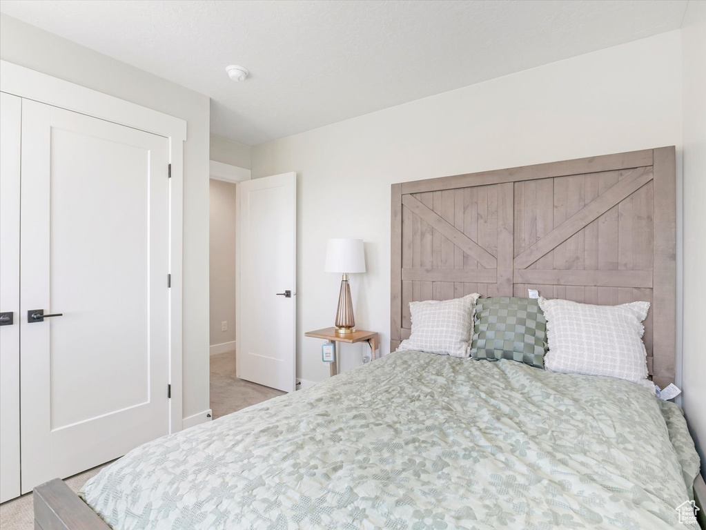 Bedroom featuring light colored carpet