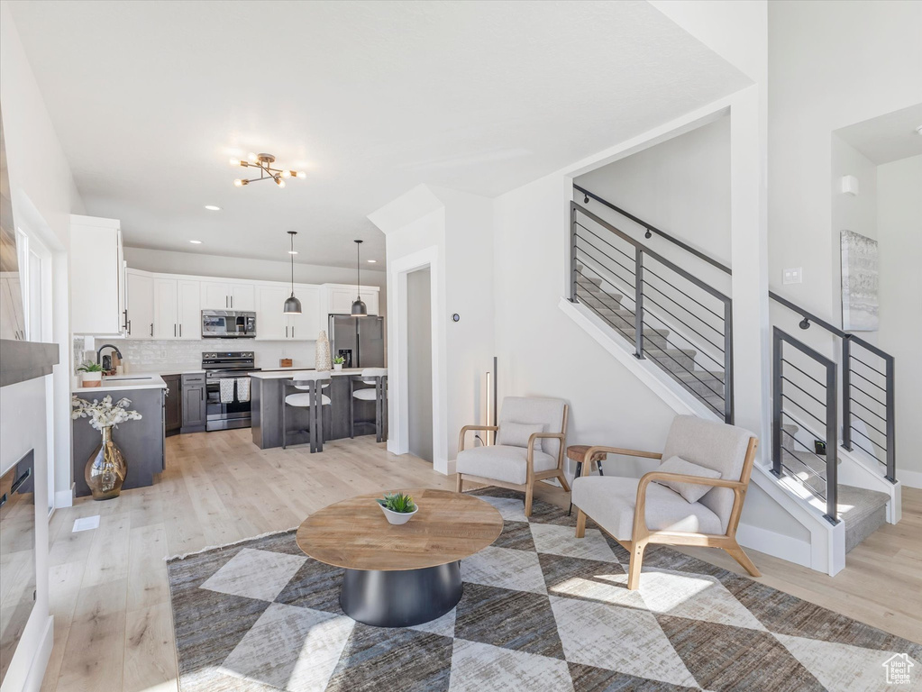 Living room featuring light wood-type flooring and sink