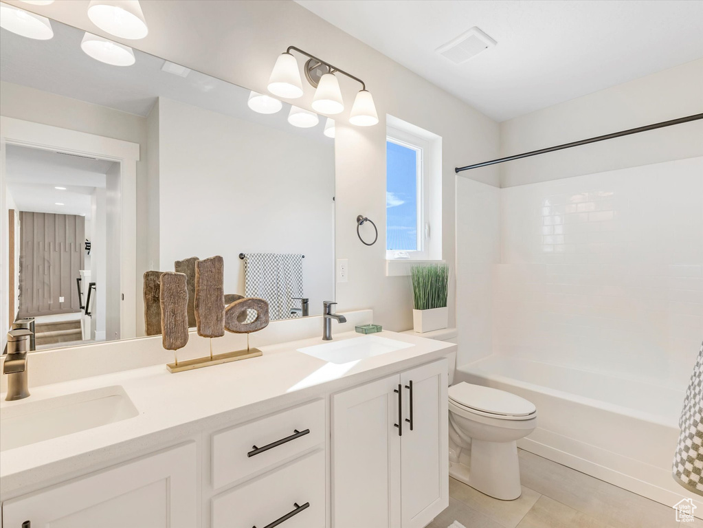 Full bathroom featuring tile patterned floors, toilet, washtub / shower combination, and vanity