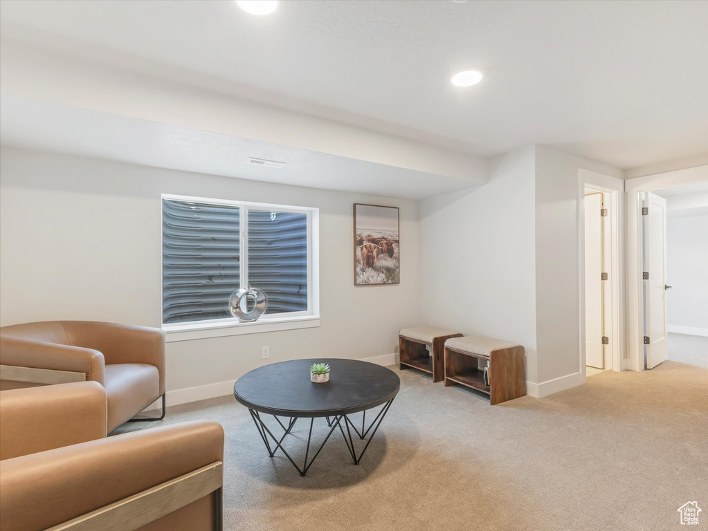 Living area featuring light colored carpet