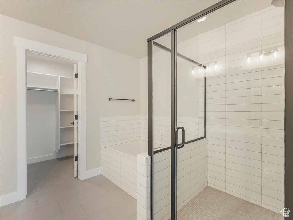 Bathroom with tile patterned floors and independent shower and bath