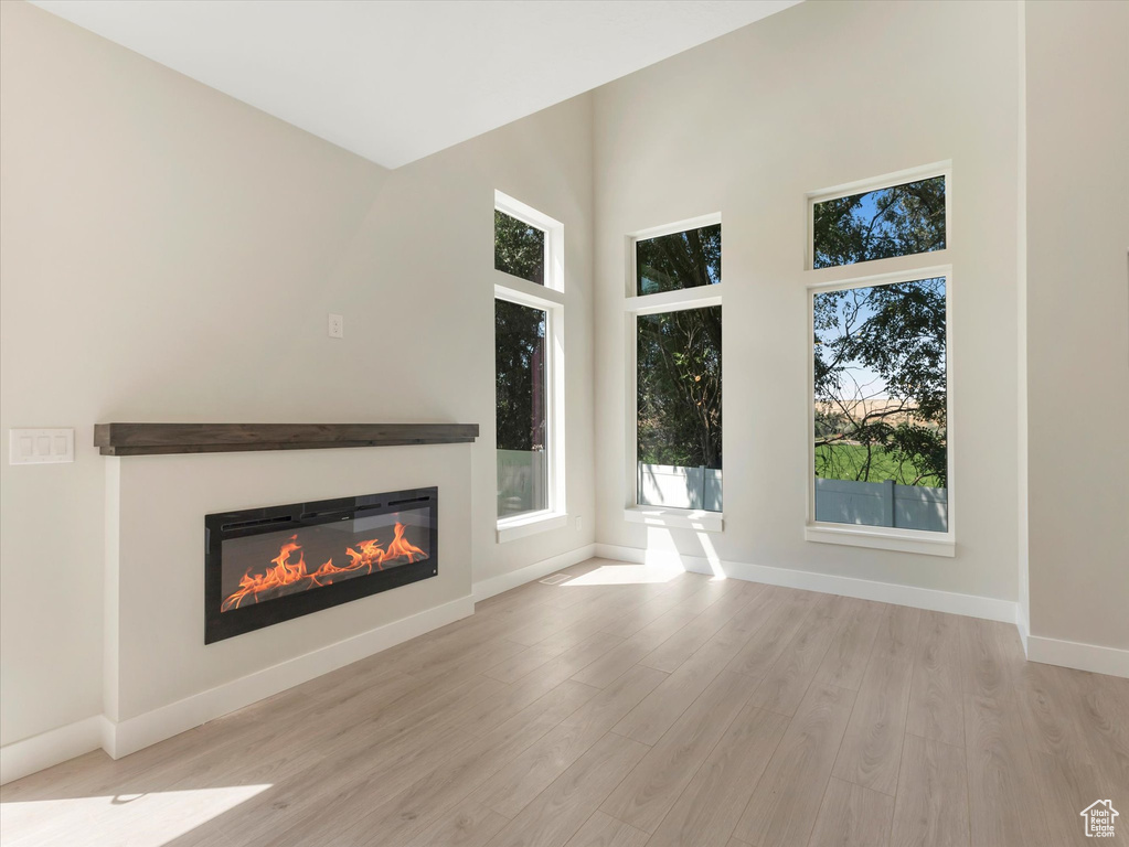 Unfurnished living room featuring light wood-type flooring