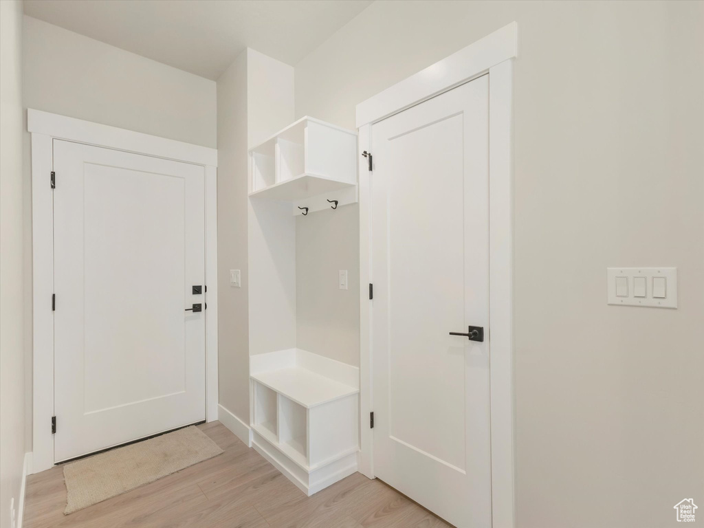 Mudroom with light hardwood / wood-style floors