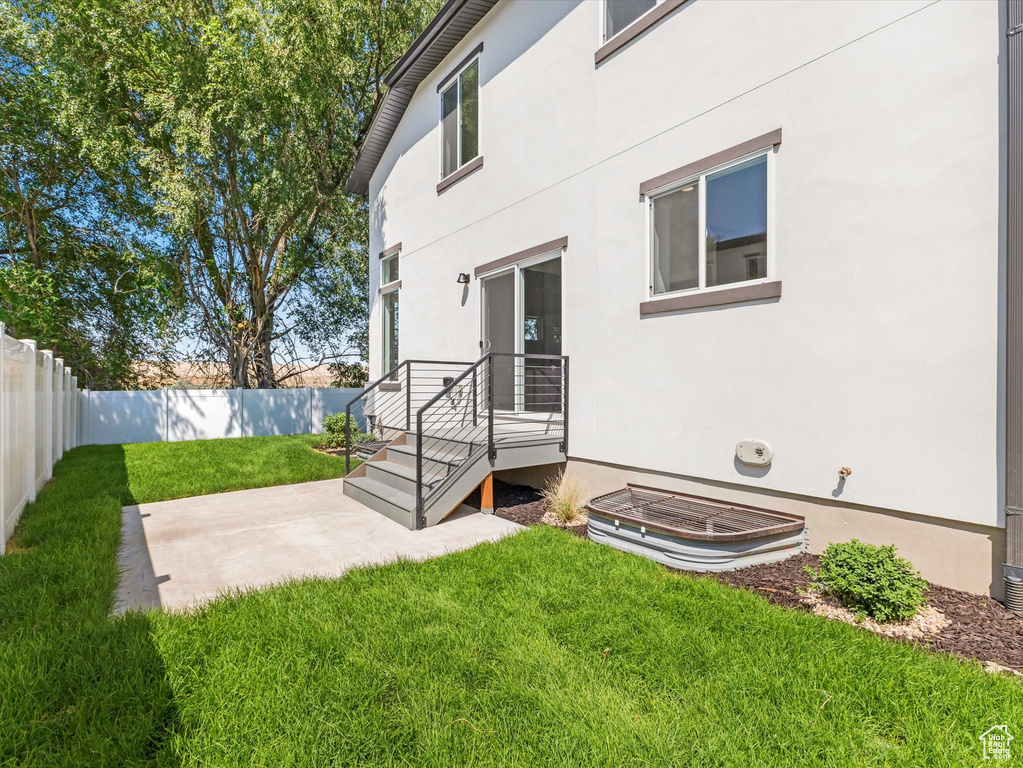 Rear view of house featuring a lawn