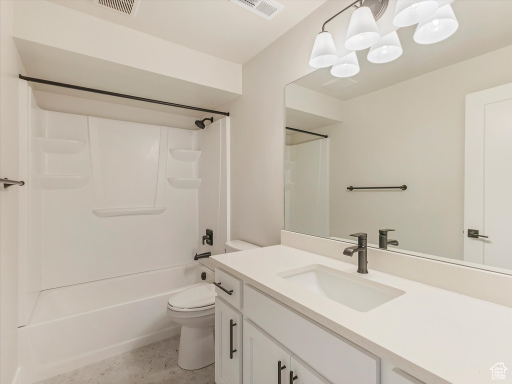 Full bathroom with shower / bath combination, vanity, tile patterned flooring, and toilet