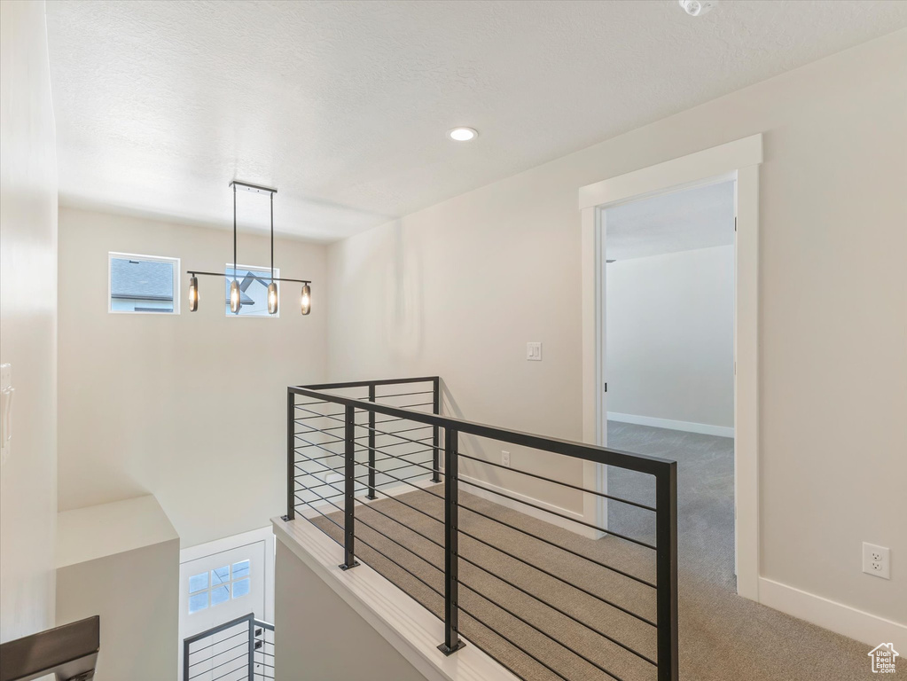 Interior space featuring carpet and an inviting chandelier