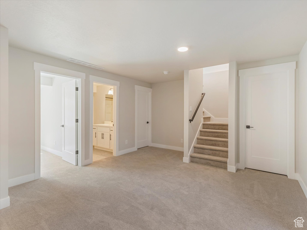 Basement with light colored carpet