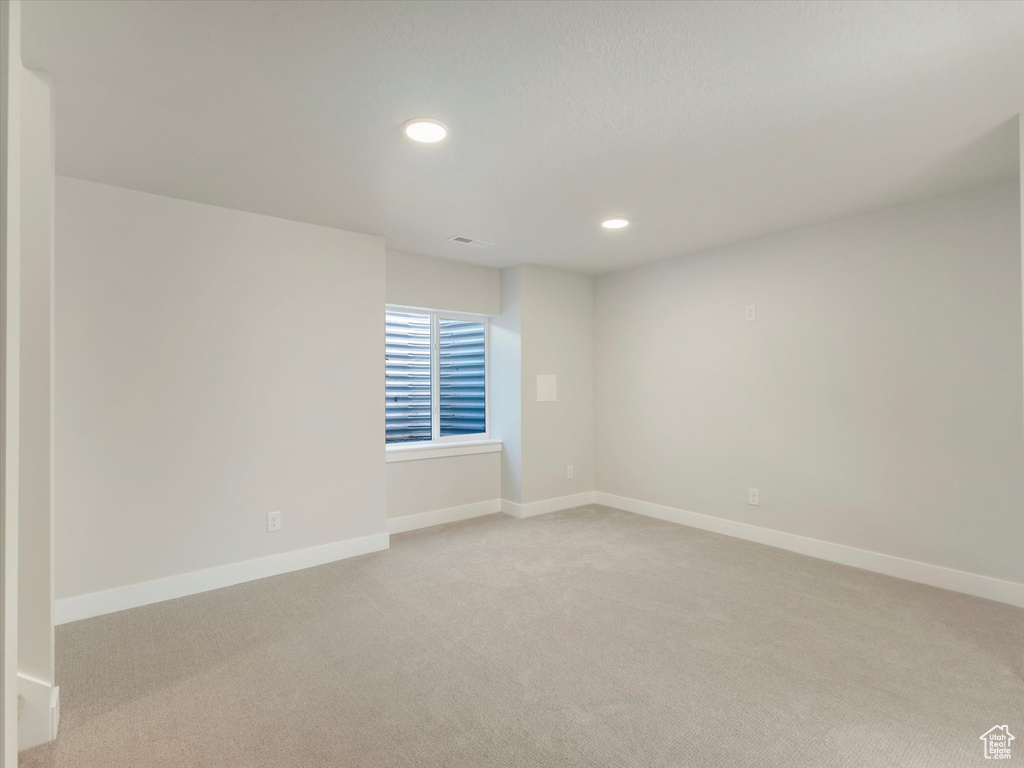 Empty room with light colored carpet