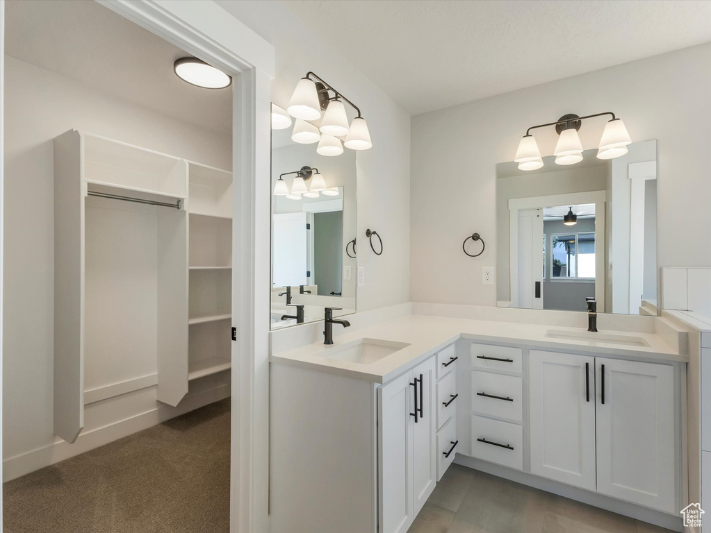 Bathroom featuring double vanity and ceiling fan