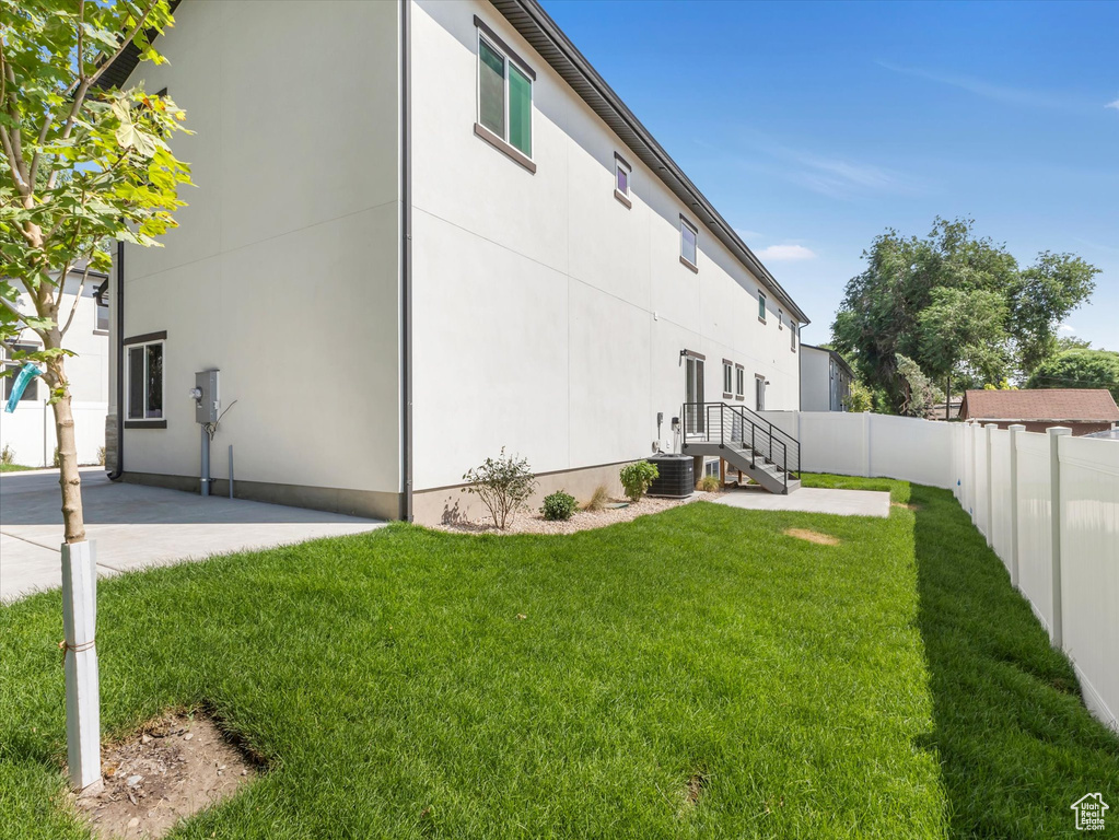 Exterior space featuring a lawn and central air condition unit