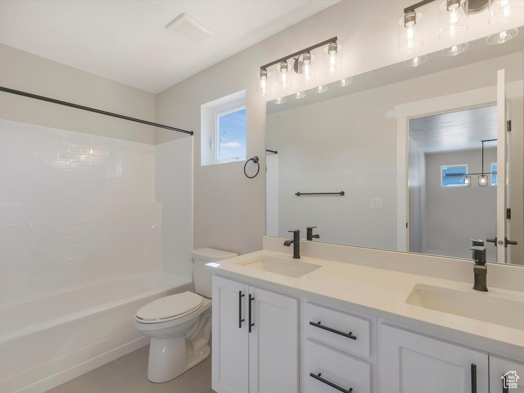 Full bathroom with shower / bathtub combination, dual bowl vanity, toilet, and tile patterned flooring