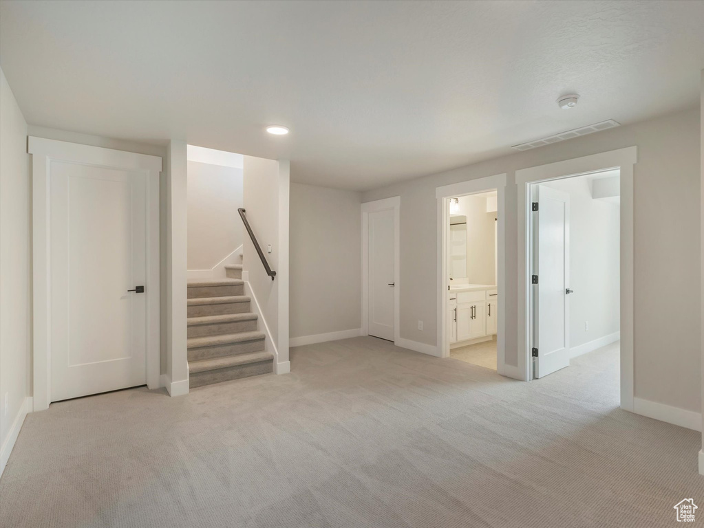 Basement with light carpet