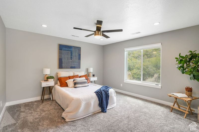 Bedroom featuring carpet flooring and ceiling fan