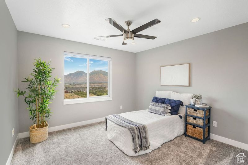 Bedroom featuring ceiling fan and carpet flooring