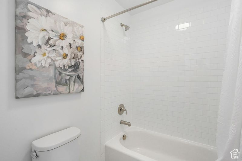 Bathroom with toilet and shower / tub combo